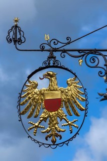 Hanging shop sign with golden eagle