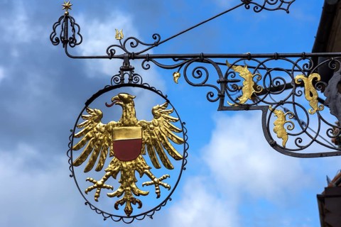 Hanging shop sign with golden eagle