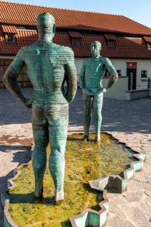 Two male figures peeing