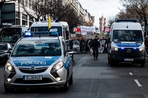 Police cars at the edge of the demonstration