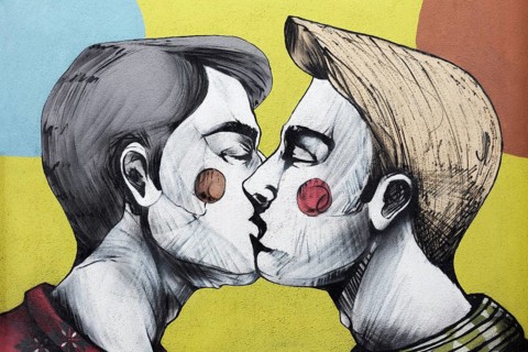 Two gay young men kissing