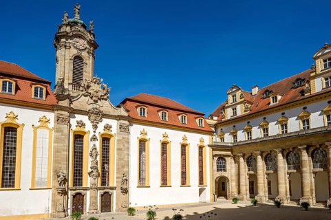 Castle courtyard with baroque castle church and colonnades