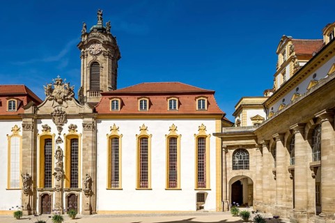 Castle courtyard with baroque castle church and colonnades