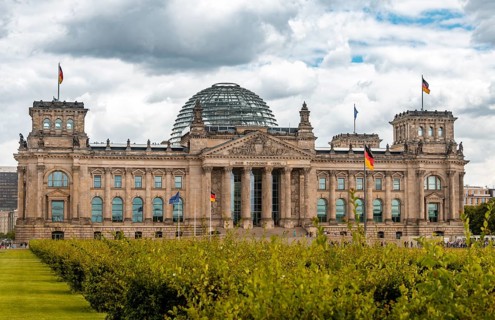 German flag flying next to the Reichstag or German parliament building
