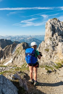 Mountaineer with backpack looking over mountains