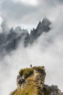 Mountaineer stands on a ridge