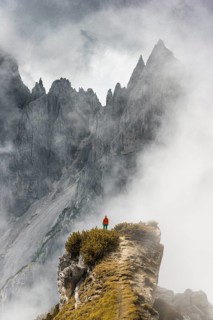 Mountaineer stands on a ridge