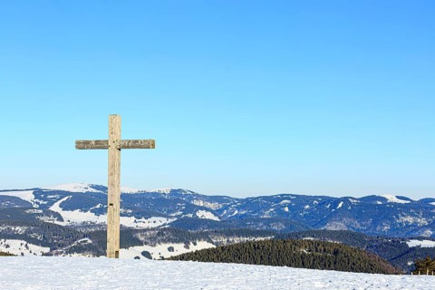 Summit cross of the Belchen in winter with snow