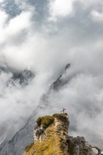 Mountaineer stands on a ridge