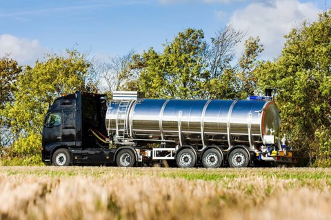Truck with silo trailer on a dirt road