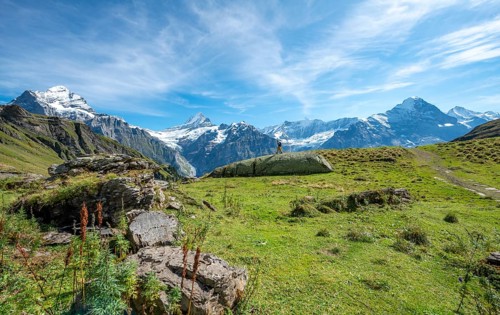 Hiker stands on a large rock