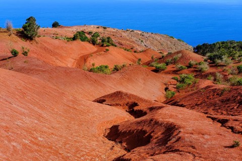 Eroded mountain slope with red earth