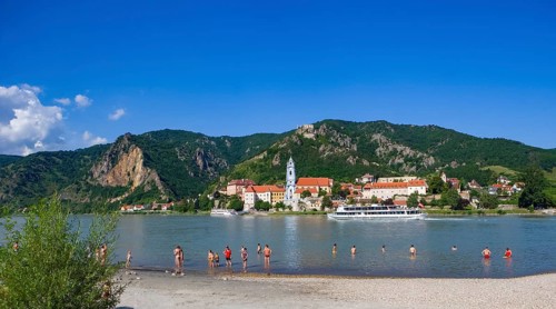 Bathing beach on the Danube with view of Duernstein Abbey