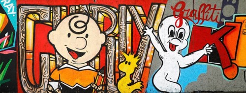Colourful graffiti on a construction site barrier