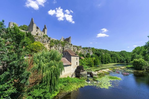 View of castle ruins and river Anglin with an old mill