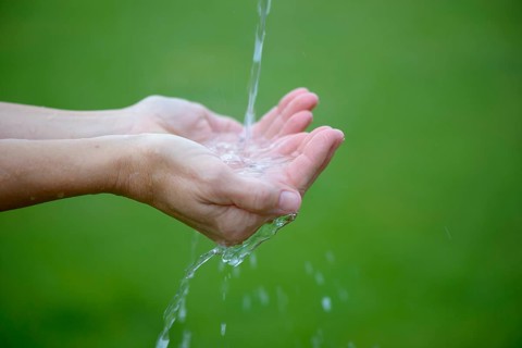 Water jet flows into hands
