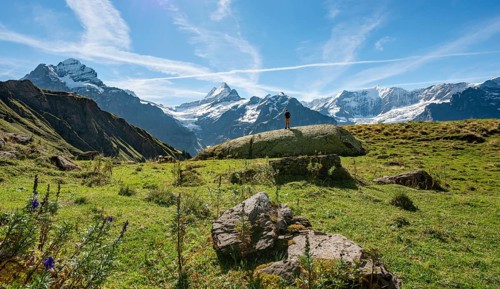 Hiker stands on a large rock