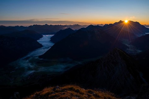 Sunrise over Lechtal Alps with fog in the valley