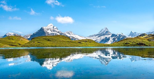 Summits Schreckhorn and Finsteraarhorn are reflected in the Bachalpsee