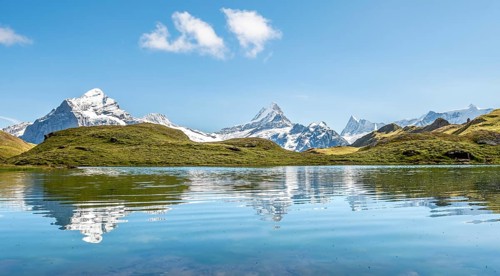 Summits Schreckhorn and Finsteraarhorn are reflected in the Bachalpsee