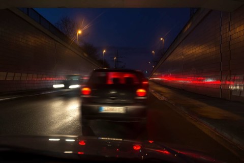 Driving cars at night in the tunnel exit