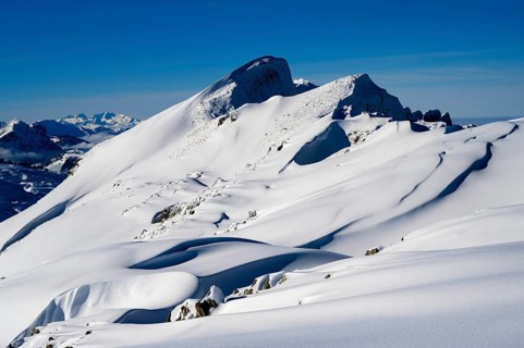 Summit of the Toreck with snow cornices and blue sky