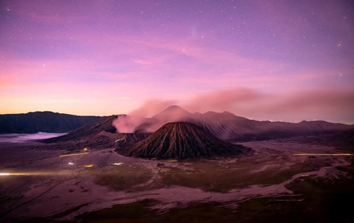 Volcanic landscape at sunrise with starry sky