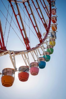 Colorful gondolas in front of a blue sky