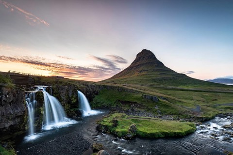 Waterfall Kirkjufellsfoss and mountain Kirkjufell at sunset