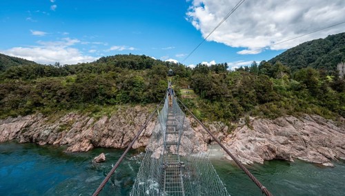 Young man on suspension bridge over Buller River