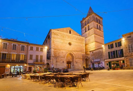 Parish church Nuestra Senyora de los Angeles and main square at dusk