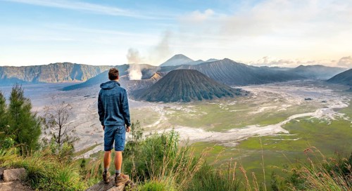 Young man in front of volcanic landscape