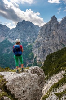 Young hiker with helmet looking at mountains