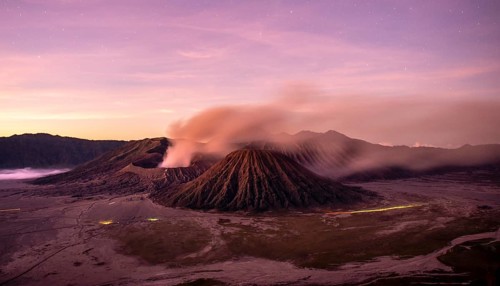 Volcanic landscape at sunrise with starry sky