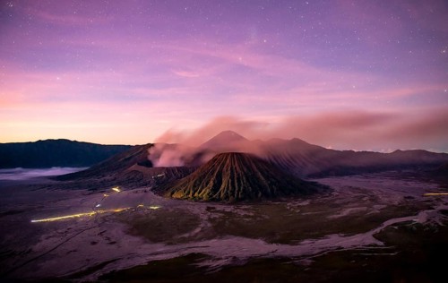 Volcanic landscape at sunrise with starry sky