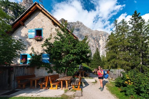 Hiker in front of a mountain hut