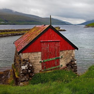 Small fishing hut on the Atlantic Ocean in the small village of Haldarsvik