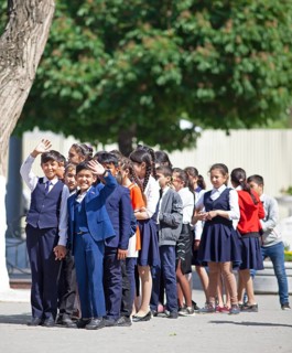 Happy students in evening dress on the university boulevard