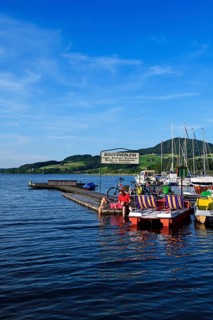 Couple with electric bikes pauses on a landing stage at Lake Obertrumer See