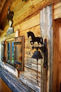 Small Swiss stone pine hut next to the mountain inn Streichen with bell made of wrought iron