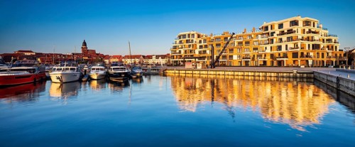 City harbour with modern hotel complex in the evening light