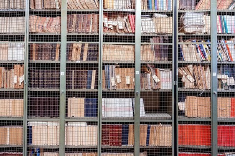 Locked bookshelves with plenty of old books
