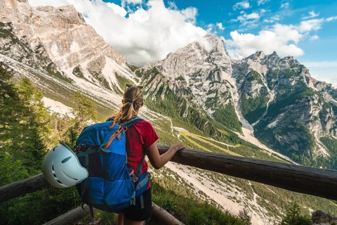 Hiker overlooks mountain landscape