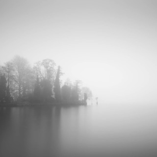 Tip of the castle island on the Dahme in Berlin Koepenick in the early morning in the thick fog