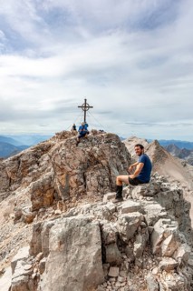 Hiker takes a break at the summit of the Birkkarspitze