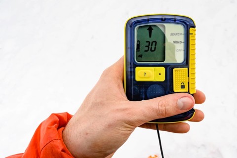 Ski tourer holds avalanche transceiver