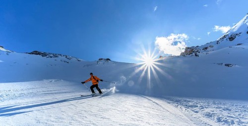Skier with touring skis skiing in the snow