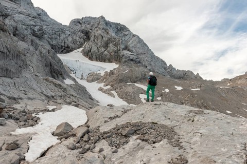 Hiker looks at alpine landscape