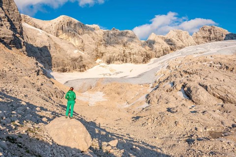 Hiker looks at alpine landscape