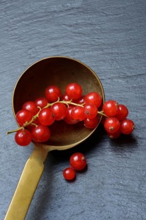 Red currants in brass ladle
